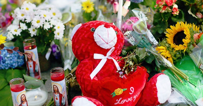 Figure 1:  Memorial at Charleston Emanuel AME church.  Such memorials are an odd way to show respect for the deceased.  Like the roadside memorials to accident victims, placing flowers on the sidewalk along with prayer candles, notes of condolence, and stuffed animals seems odd.  Why is it always a Teddy Bear?